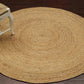 Round handwoven jute rug in a warm golden color